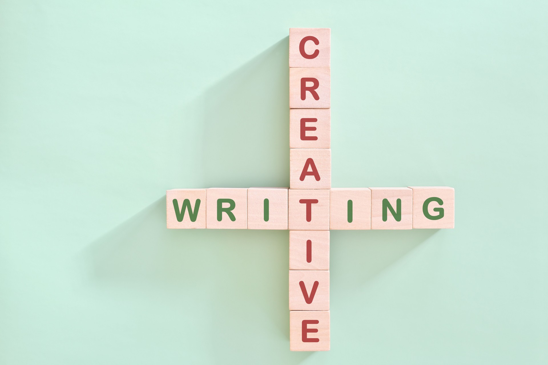 Creative writing concept. Crossword puzzle flat lay typography in green background.